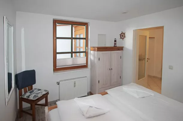 Schlafzimmer mit Doppelbett und Kommode
